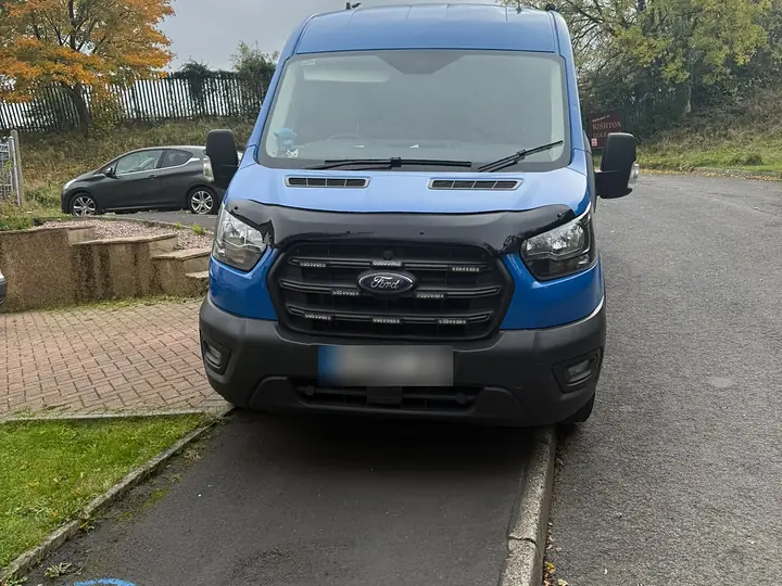 The blue Pro Flow drainage van parked on a residential street